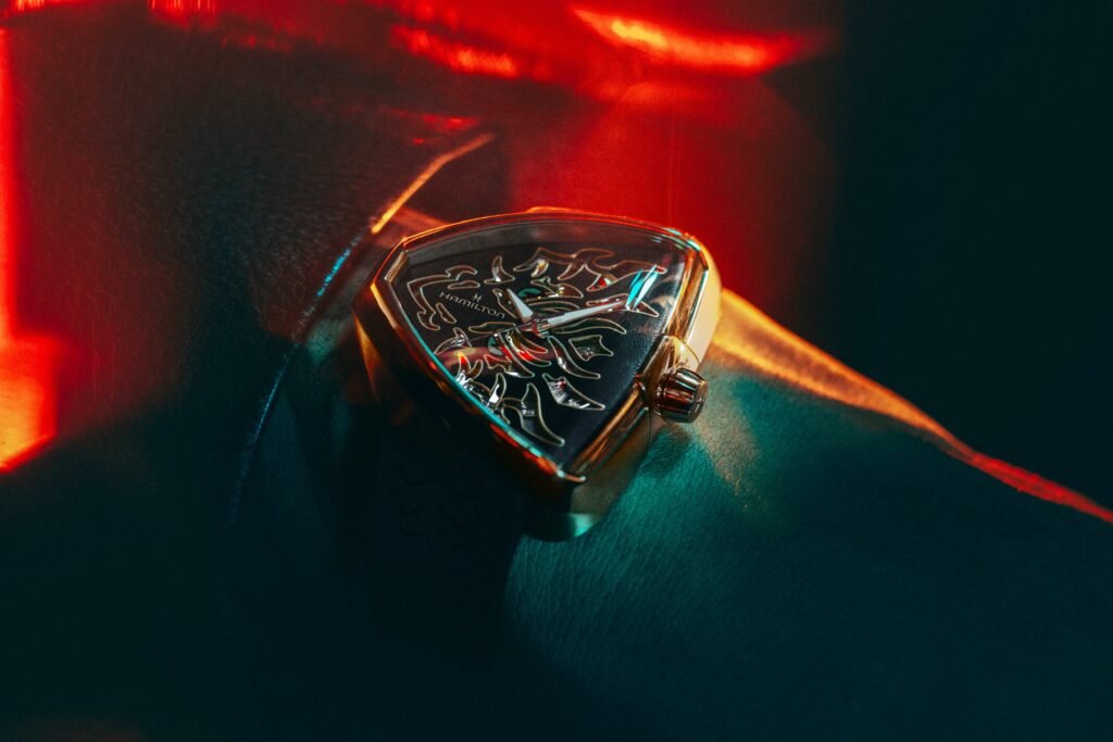 Hamilton Ventura Dragon wristwatch on the wrist in a dark setting