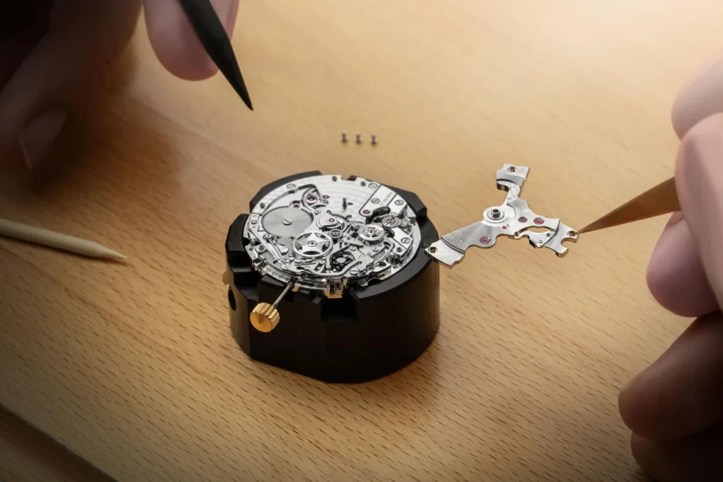 Gold & blue Breguet Type 20 wristwatch movement being assembled by ywatchmaker