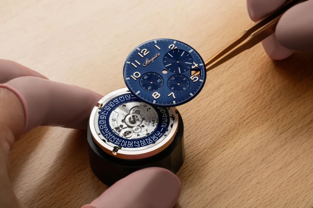 Gold & blue Breguet Type 20 wristwatch movement being assembled by ywatchmaker