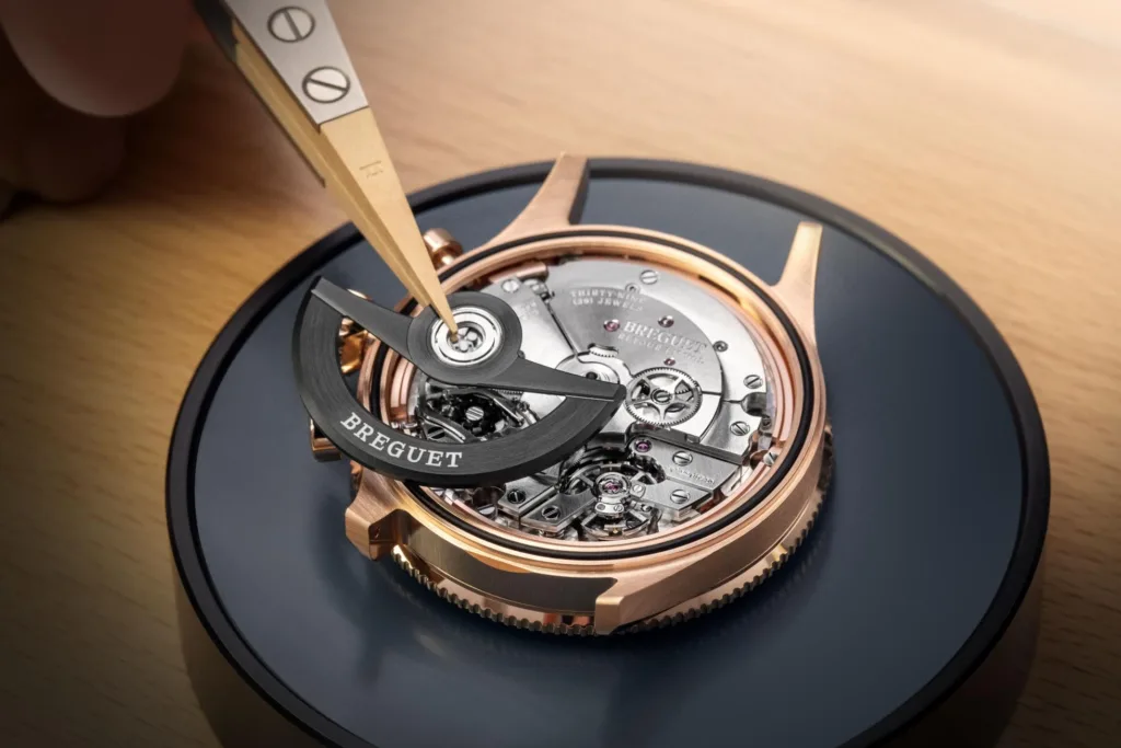 Gold & blue Breguet Type 20 wristwatch movement being assembled by ywatchmaker