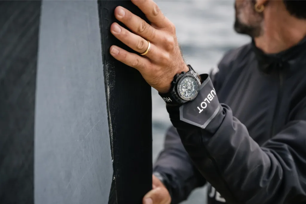 Hublot Big Bang Unico Sailing Team watch worn on the wrist on sailing yacht modelled by Alan Roura