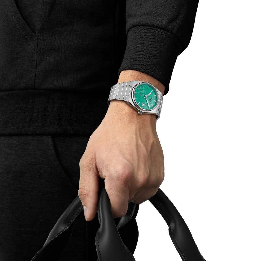 Tissot PRX watch with mint green dial worn on the wrist of model