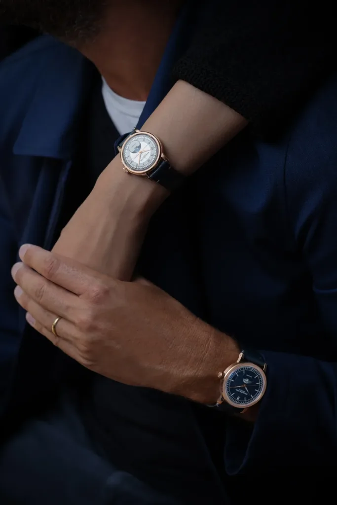 Pair holding hands, wearing Raymond Weil Millesime watches