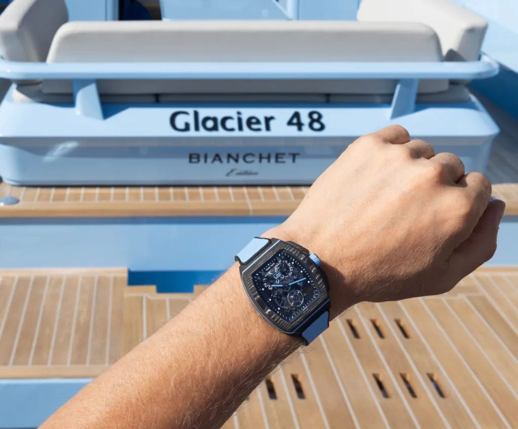 Bianchet Sport tourbillon worn on the wrist against a backdrop of a Glacier Yacht in matching tones.