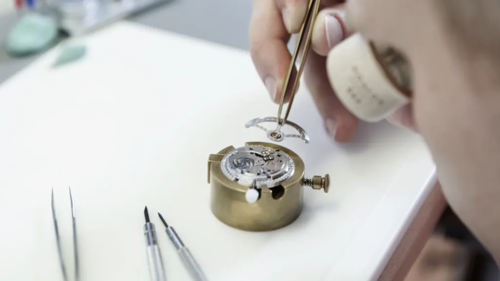 NOMOS watchmaker applying the rotor to a self-winding automatic movement