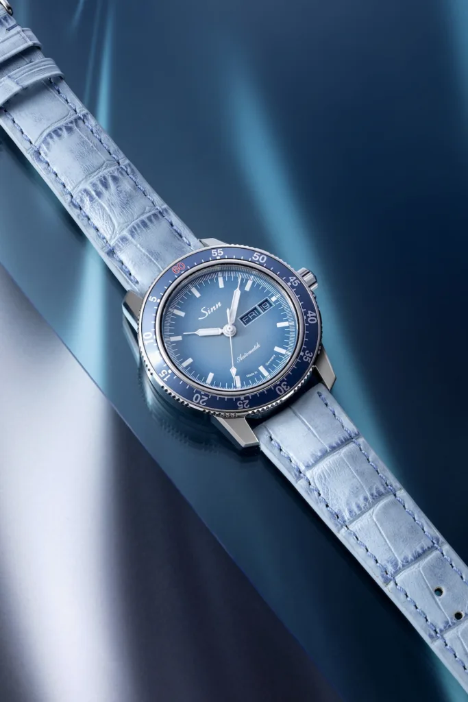 Sinn 104 Watches of Switzerland limited edition watch on blue background