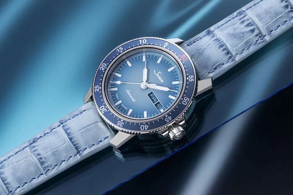 Sinn 104 Watches of Switzerland limited edition watch on blue background